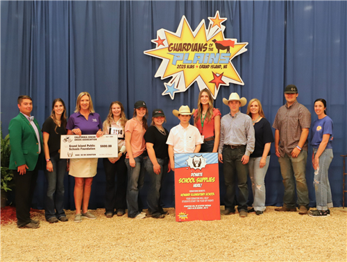 Jennifer Worthing, GIPS, holding big check donation and smiling with members of the Angus Board and NJAA members.